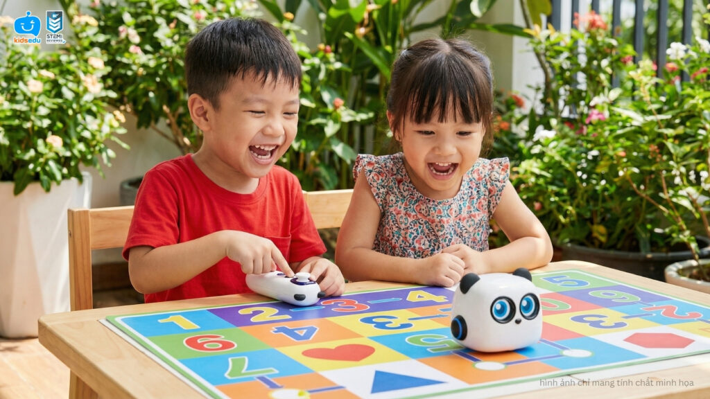 Two smiling children interacting with a panda-themed programmable robot on a colorful number grid mat.