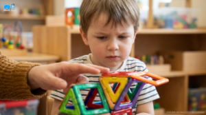 A focused preschool child engaging with magnetic building blocks at a KidsEdu STEM school.